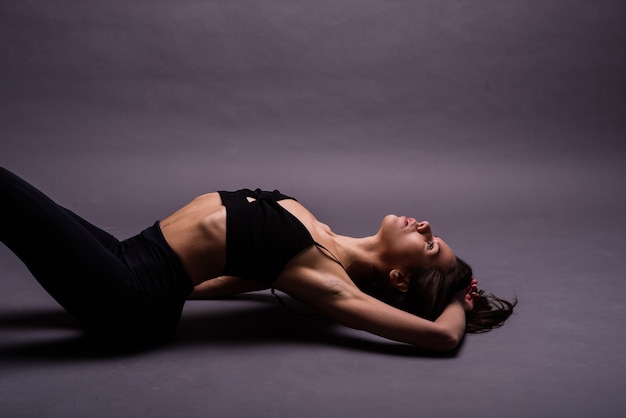 Modern style dancer posing on studio background