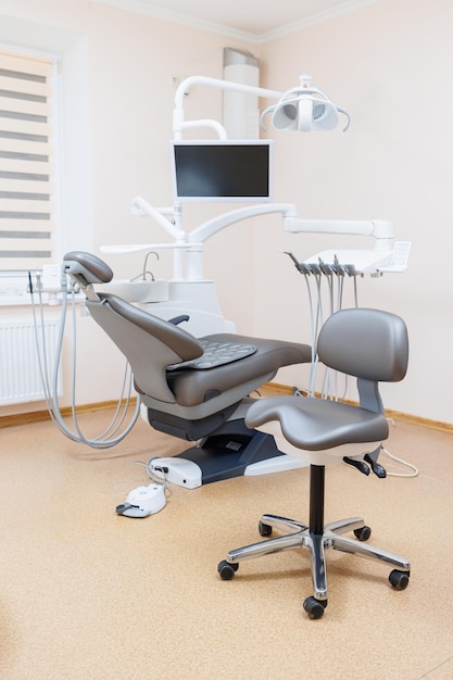 Modern stylish bright dental office with a new chair for receiving patients selective focus