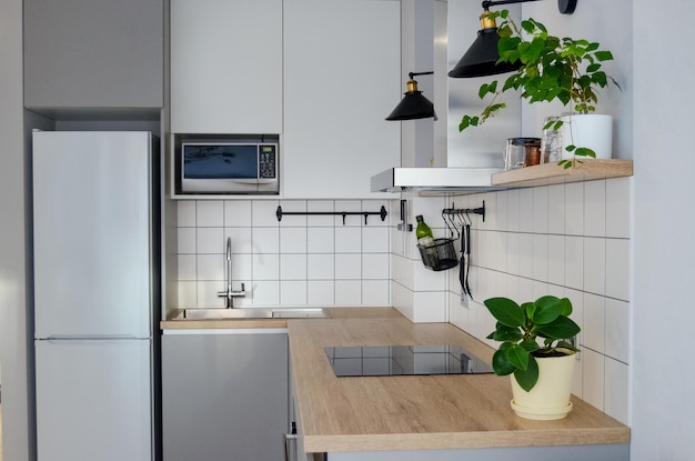 Modern stylish Scandinavian kitchen interior with kitchen accessories. Bright white and grey kitchen