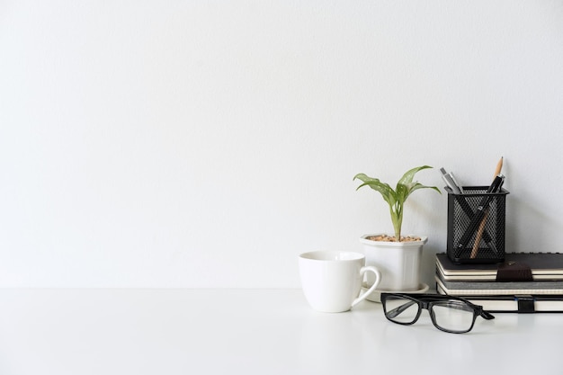 Modern and stylish workspace mock up with desk office supplies and white background and copy space