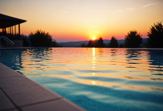 A modern swimming pool glistens under the sunsets hues