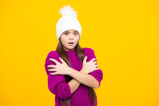 Modern teen girl wearing sweater and knitted hat on isolated yellow background Angry teenager girl upset and unhappy negative emotion