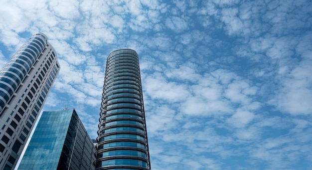 Modern tower buildings or skyscrapers in financial district with cloud on sunny day