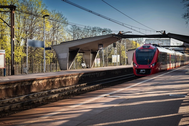 The modern train arrives at the platform at the train station