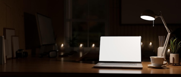 Modern vintage home workspace at night with laptop mockup and copy space on wood table