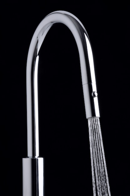 Modern water tap with jet on black