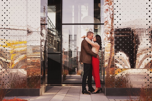 modern wedding romantic date stylish couple fashionable clothes kissing hugging on city street