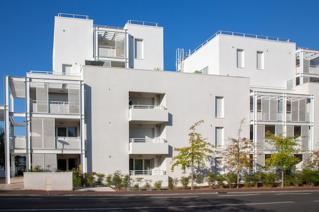 Modern white contemporary residential square building with balcony