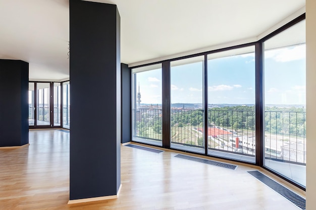 Modern white empty loft apartment interior with parquet floor and panoramic windows Overlooking the metropolis city