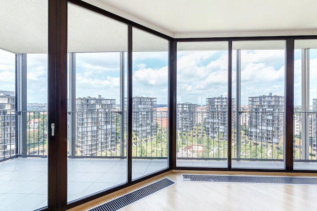 Modern white empty loft apartment interior with parquet floor and panoramic windows Overlooking the metropolis city