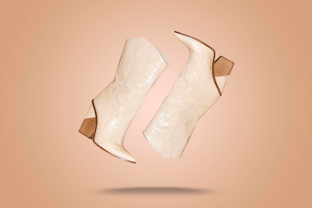 Modern white high heel boots fashion female style isolated on bright background