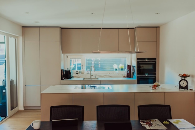 Modern white kitchen with electronic devices and decorative items