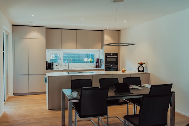 Modern white kitchen with electronic devices and decorative items