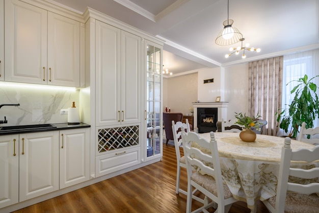 Modern white large luxurious kitchen and dining room in studio apartment