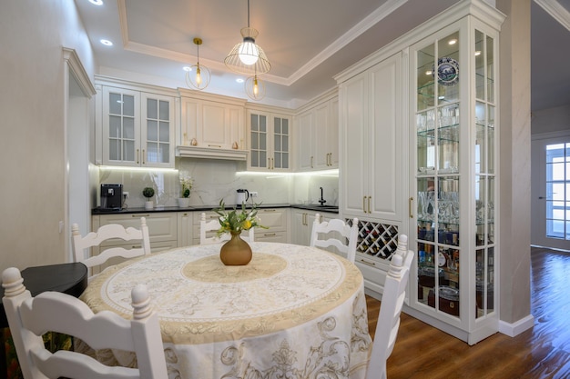 Modern white large luxurious kitchen and dining room in studio apartment