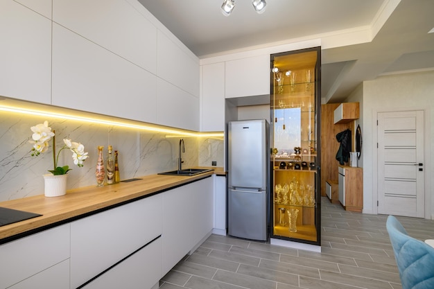 A modern white studio with a kitchen ready to use