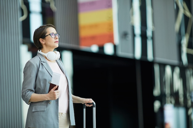 Modern woman reading flight schedule