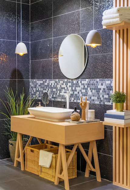 Modern wooden bathroom with mirror, toilet, cabinet and sink