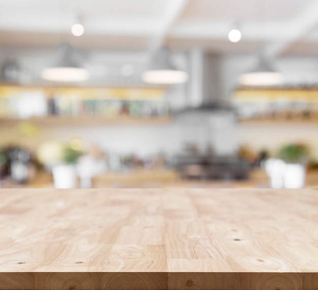 Modern wooden board empty table in front of blurred kitchen background .Perspective table top used for display or montage your products