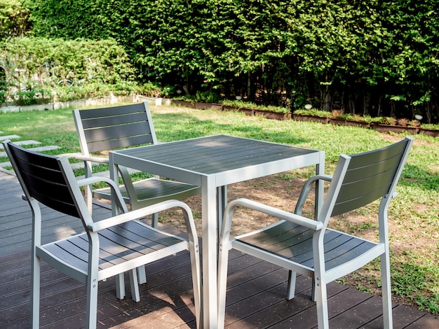 Modern wooden dining table set in the green garden