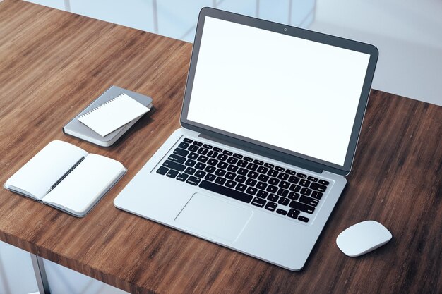 Modern wooden office desktop with empty laptop