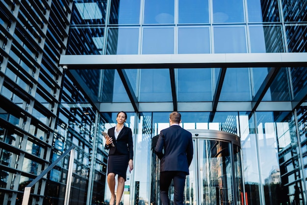 Modern worker of office building on street