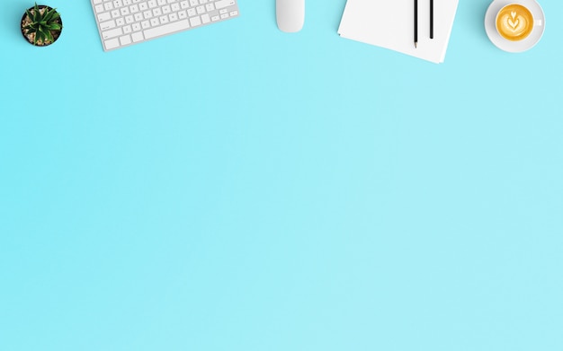 Modern workspace with coffee cup, keyboard and blank paper on Blue color