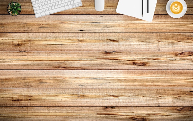 Modern workspace with coffee cup, paper, notebook and keyboard on wood