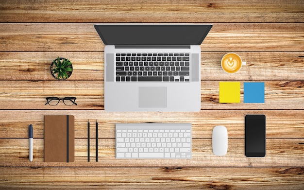 Modern workspace with coffee cup, paper, notebook, tablet or smartphone and laptop on wood