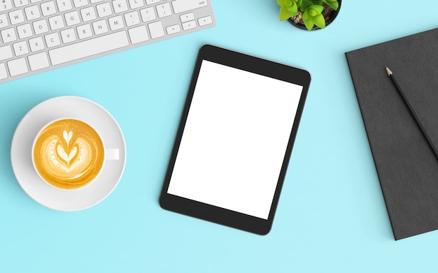 Modern workspace with coffee cup, smartphone, keyboard and notebook on Blue color