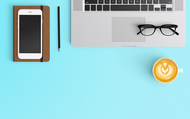 Modern workspace with coffee cup, smartphone, notebook and laptop on Blue color