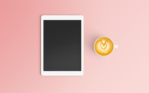 Modern workspace with coffee cup and tablet on pink color