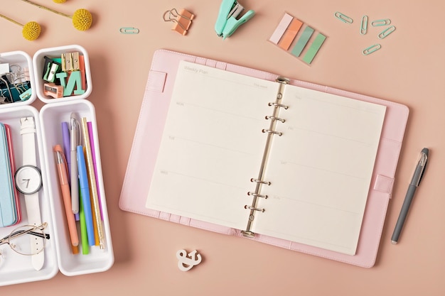 Modern workspace with notebook office stationary in plastic organizers