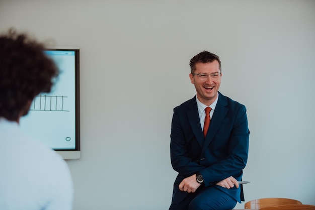 A modernly dressed professor engages in educating students who listen attentively creating a dynamic