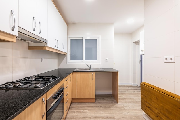 Modular furniture in kitchen with white cabinets on top of wall and cabinets with wood doors below