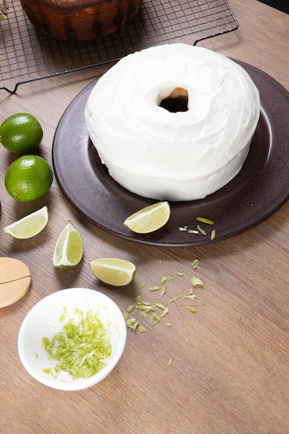 Moist lemon fruit cake on plate with lemon slices on wooden table Delicious breakfast traditional tea time Lemon cake recipe Top view