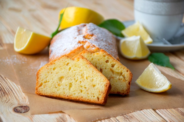 Moist lemon pound cake with sugar powder on parchment