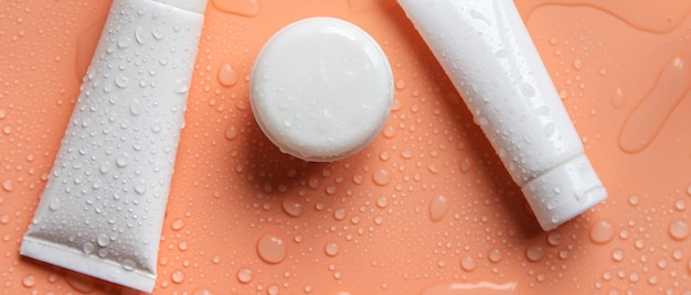 Moisturizing cosmetics on a wet background Selective focus