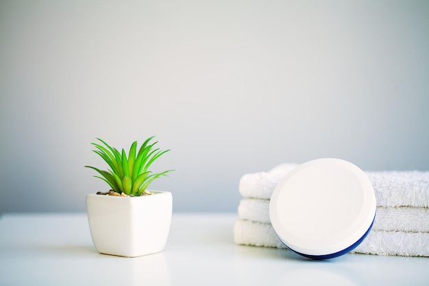 Moisturizing cream towels and aroma oil on table in bath room