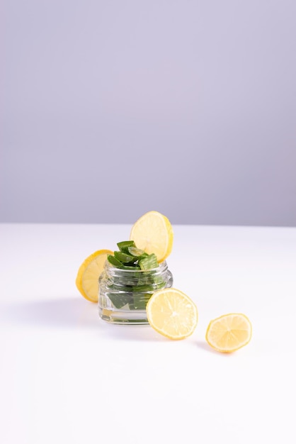 Moisturizing summer cosmetics based on natural ingredients in a glass container on a white background