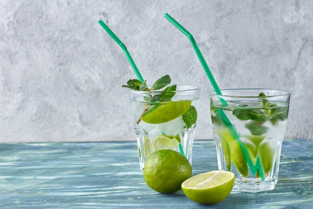 Mojito cocktail on the grey concrete background.