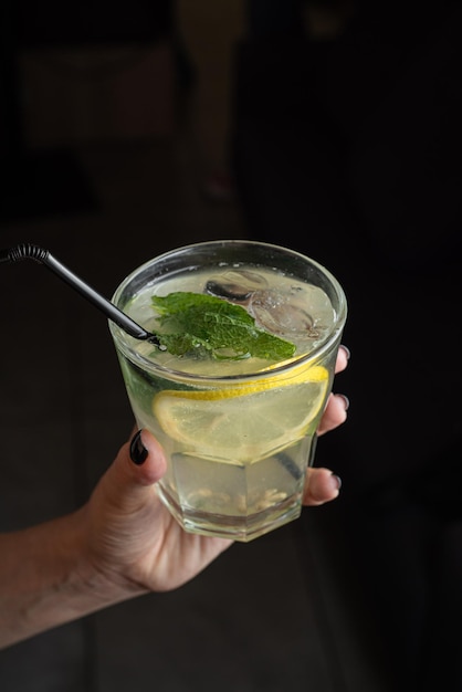 Mojito cocktail with lime and mint in glass