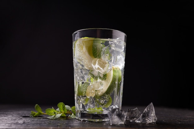 Mojito cocktail with lime, mint and ice cubes isolated