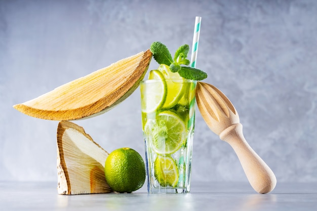 Mojito in glass with lime, fresh mint and ice