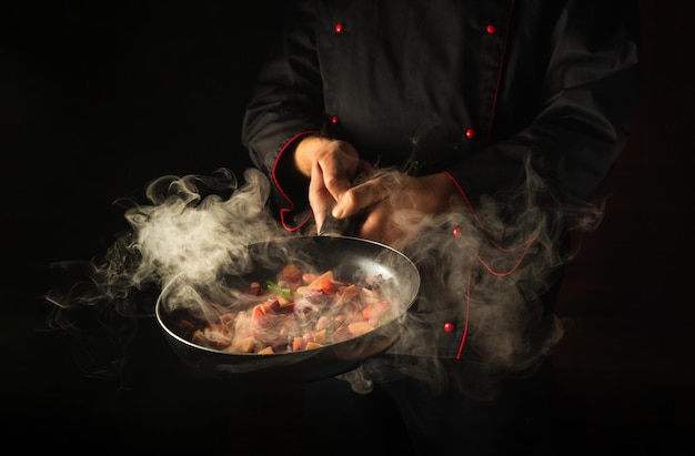 Molecular gastronomy or cuisine Cook cooking vegetables in a hot pan