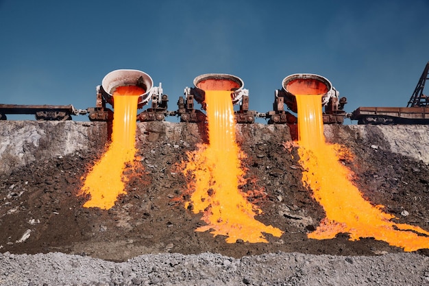 Photo the molten slag is poured from a crucible mounted on a railway platform a stream of molten slag