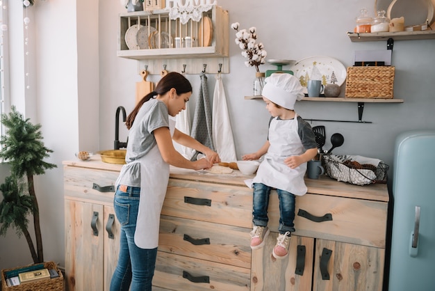 mom and boy preparing dough for Christmas cookies