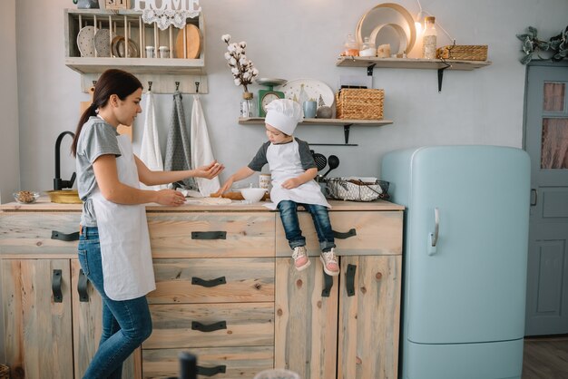 mom and boy preparing dough for Christmas cookies