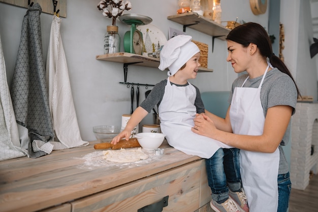 mom and boy preparing dough for Christmas cookies