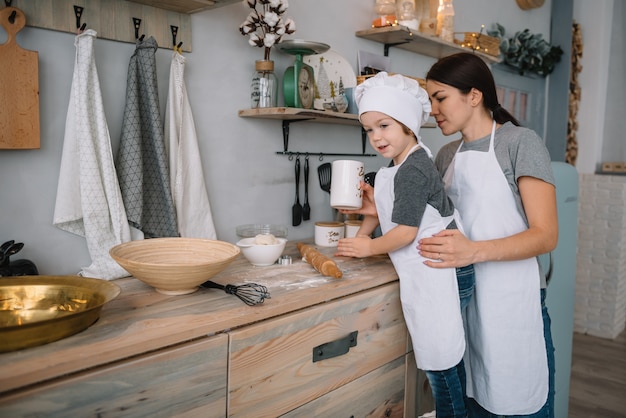 mom and boy preparing dough for Christmas cookies